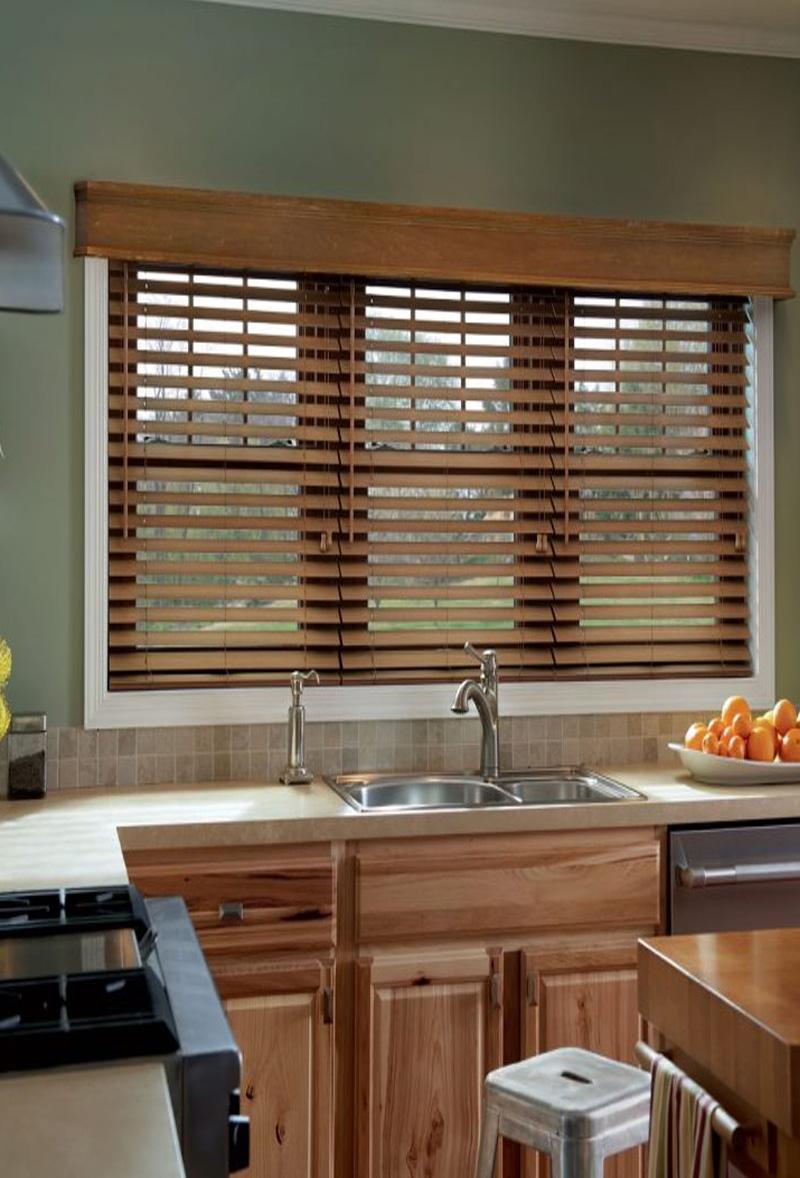 Faux wooden Venetian blinds fitted above kitchen sink window by Poppy Blinds