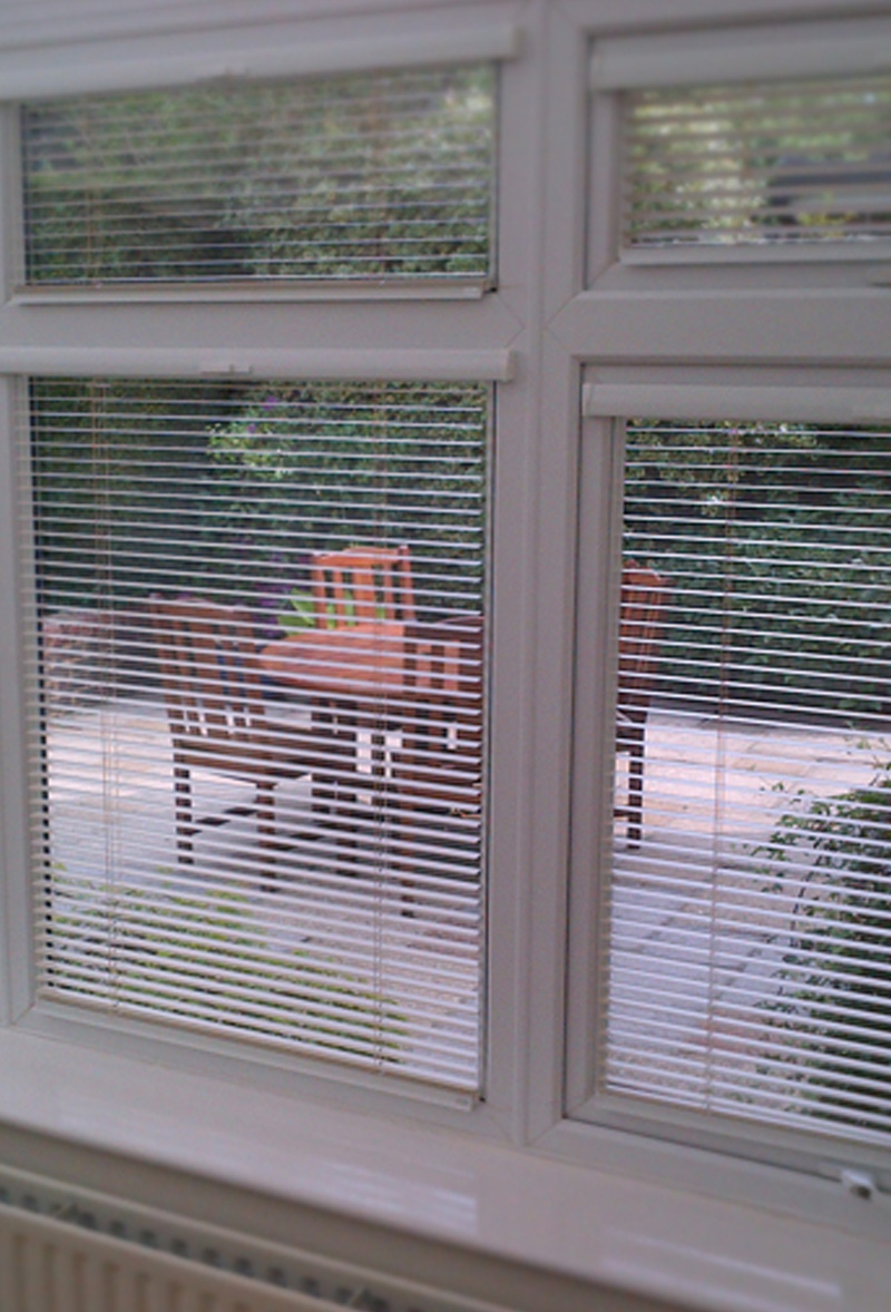 White Venetian blinds fitted to bay window in Warrington home by Poppy Blinds